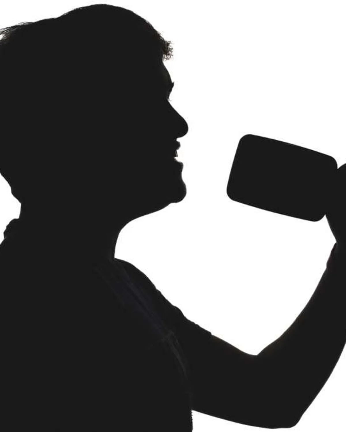 Ganesh Venkataraman of The Untitled Band, captured in profile silhouette singing into a microphone.